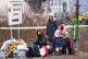 Refugees from Ukraine rest after arriving to the border cros