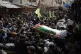 Palestinian mourners carry the body of Nader Rayan, 16, who 