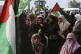 Women wave Palestinian flags during a rally marking the 46st