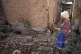 Hanna Sylivon, 76, stands inside her house destroyed by atta