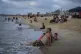 A man enjoys a day on the beach with his daughter in Gaza Ci