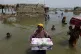 Women salvage whatever they can in the Qambar Shahdadkot dis