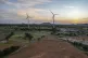 A windmill farm works as the sun sets in Anantapur district,