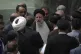 Iranian President Ebrahim Raisi is surrounded by a group of 