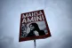 A woman holds a placard with a picture of Iranian Mahsa Amin