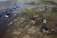 Houseboats sit amid drought-impacted land near the Solimões