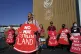 Demonstrators hold signs as part of a protest demanding no m