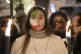 A protester with an Iranian flag painted on her face partici