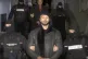 FILE PICTURE: Andrew Tate is led away by police in the Ilfov