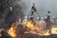 Activists build barricades and set them on fire while the po
