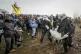 Police officers carry a demonstrator to clear a road at the 