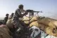 A Yemeni fighter backed by the Saudi-led coalition fires his