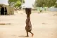 A child passes by carrying a bucket in Yola, Nigeria, April 