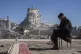 Mehmet Nasir Duran, 67, sits on a chair as heavy machines re