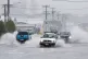 Cars move through flooded roads in the northern New Zealand 