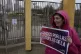 A Los Angeles Unified School District teacher holds a sign d