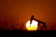 A pump jack operates as the sun begins to set on March 7, 20