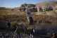 People walk by a formerly sunken boat standing upright into 