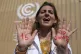 A demonstrator shows her hands reading 