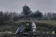 Ukrainian soldiers fire a self-propelled howitzer towards Ru