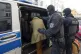 Masked police officers lead the arrested suspect Heinrich XI