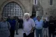 Garo Nalbandian, an 80-year-old photojournalist, center, lis