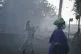A Sudanese evacuee carries her son as they disembark from th