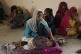 A woman takes care of her child as she with other families t