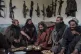 Taliban fighters enjoy lunch inside an adobe house that is u