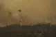 A firefighting helicopter dumps water in Mandra west of Athe