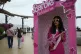 An anti-government protester, dressed as Barbie holding a fa