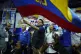 Presidential candidate Fernando Villavicencio waves an Ecuad