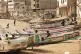 Children play on fishing boats known as ‘pirogues’ in Da
