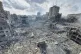 Palestinians walk through the rubble of buildings destroyed 