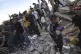 A Palestinian takes a child out of the rubble after Israeli 