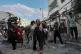 Palestinian families rush out of their homes after Israeli a