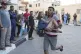 A Palestinian rushes his child wounded in the Israeli bombar