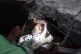 Palestinians try to rescue a girl stuck under the rubble of 