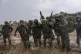 Israeli soldiers prepare to enter the Gaza Strip, at a stagi