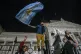 Demonstrators climb a fence outside Congress during protests