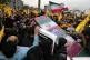 Iranian mourners carry the flag-draped coffin of Seyed Razi 