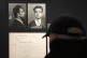 A visitor watches the Nov. 18, 1943 police mugshot of Missak