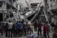 Palestinians inspect the damage of residential buildings aft