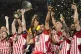 Olympiacos' Ayoub El Kaabi (centre) celebrates after winning