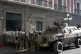 An armored vehicle and military police form outside the gove