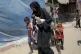 Palestinians evacuate from a site hit by an Israeli bombardm