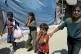 Palestinian children are evacuated from a site hit by an Isr
