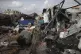 Displaced Palestinians inspect their tents destroyed by Isra