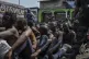 Arrested members of the Wazalendo sect are sat and lined up 