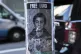 A poster depicting Luigi Mangione hangs outside the New York